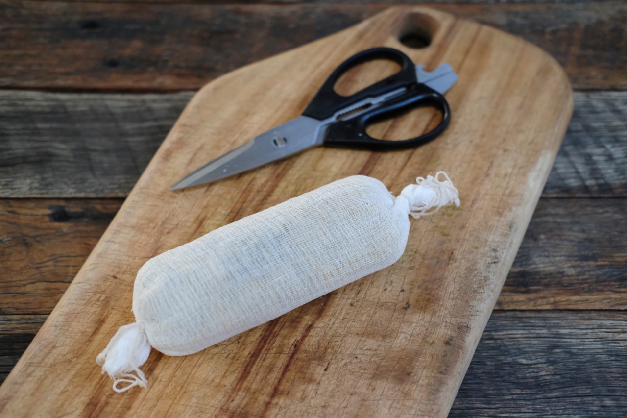 Swiss Chard Pasta Roll, wrapped in muslin cloth, ready to be cooked