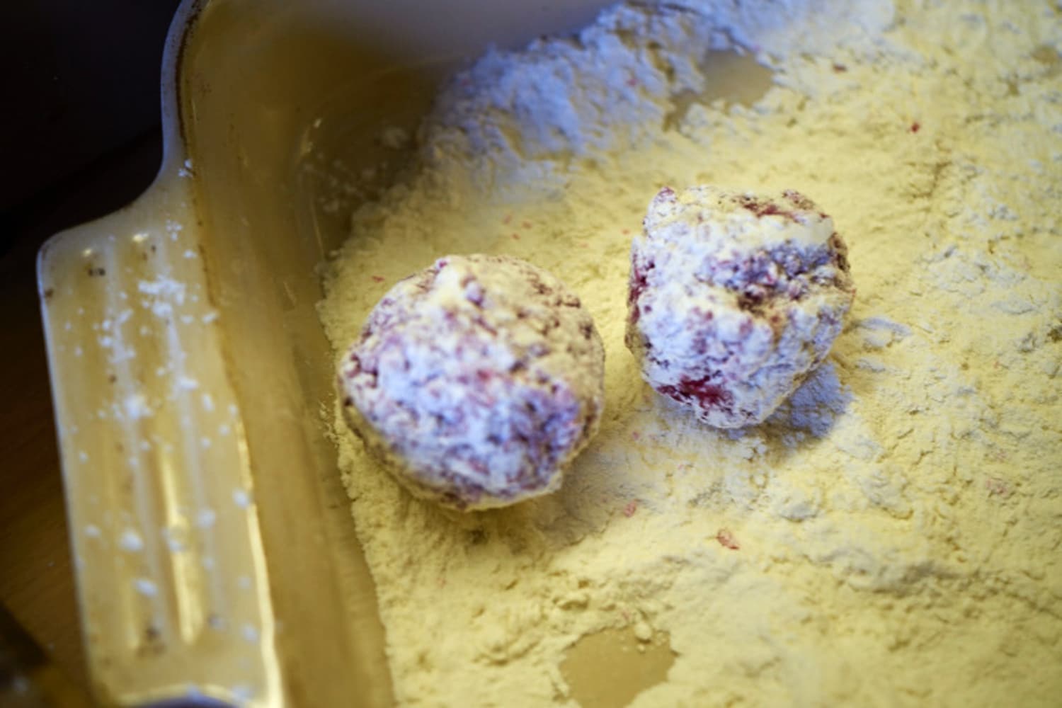 Coating the balls in flour