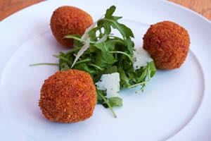 Arancini, served with a rocket and parmasan salad